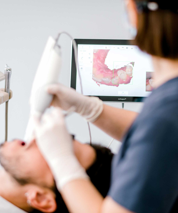 Sunshine-14 Dentist scanning patients teeth for common dental problems